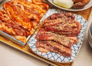 Marinated pork and beef strips on plates ready for the grill